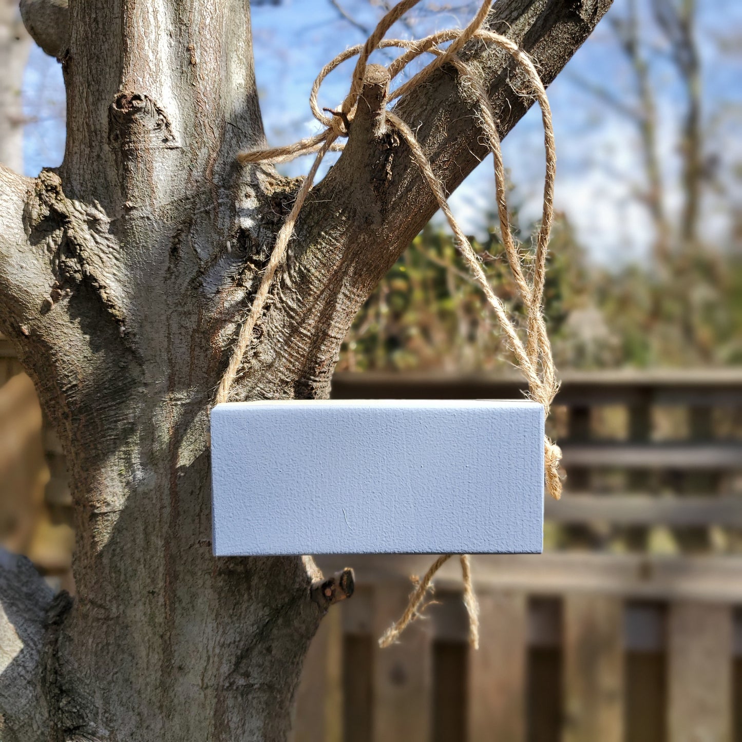 gray tree marker hanging on a tree branch