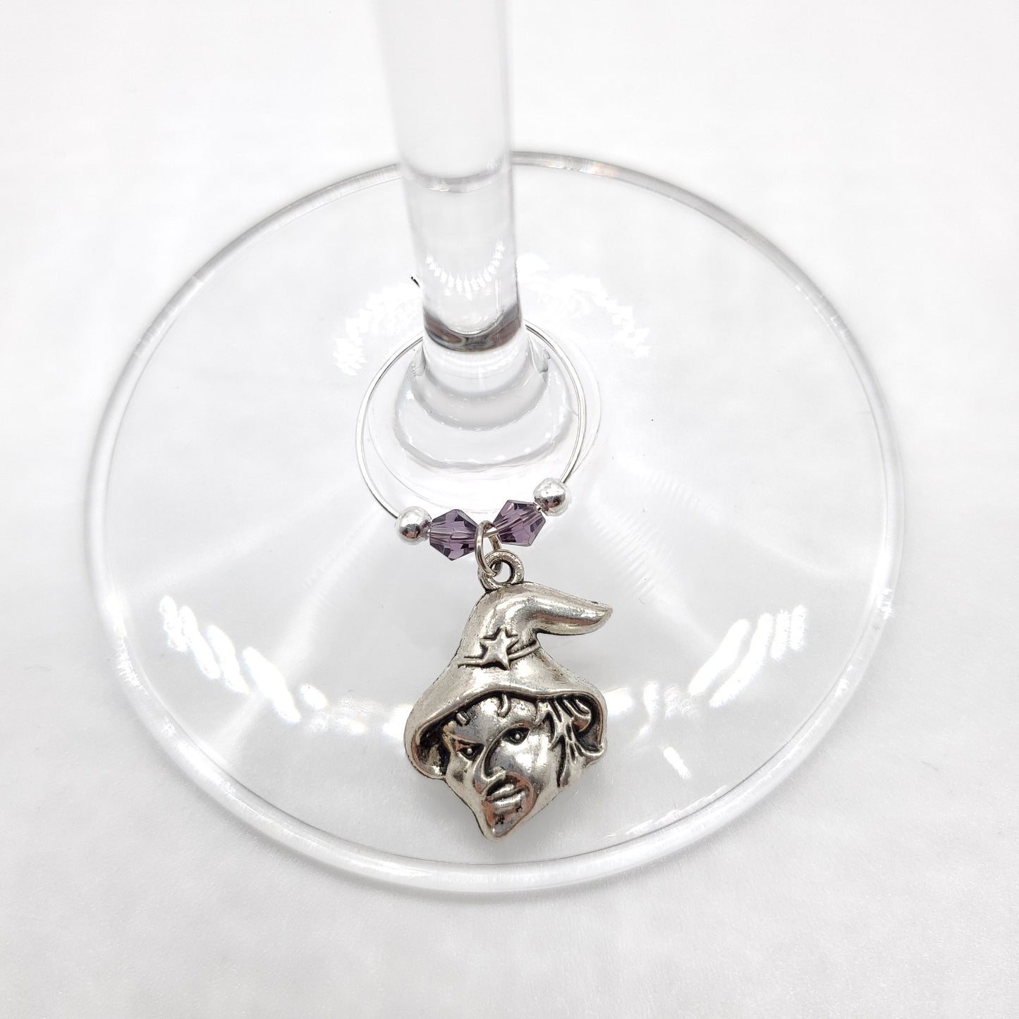 Witch head wine charm displayed on wine glass