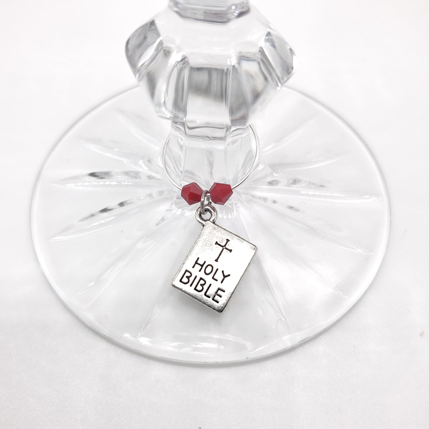 bible wine charm on a glass with red beads