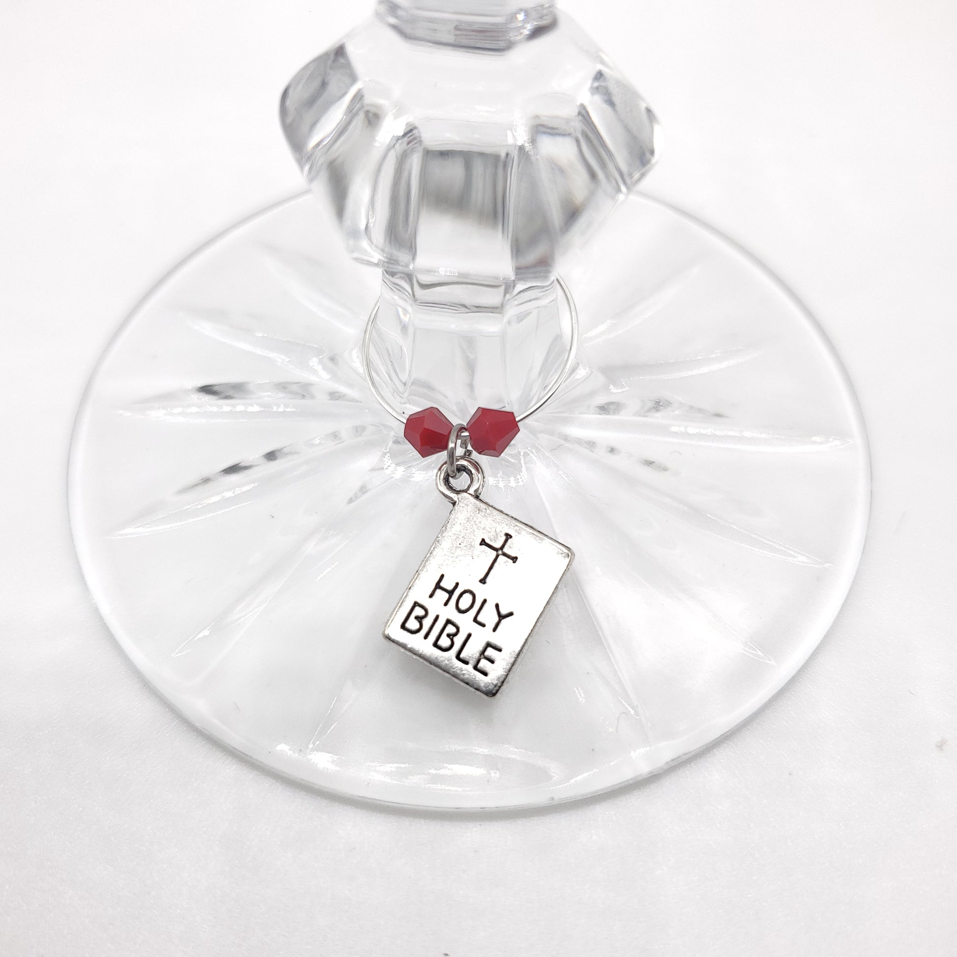 bible wine charm on a glass with red beads