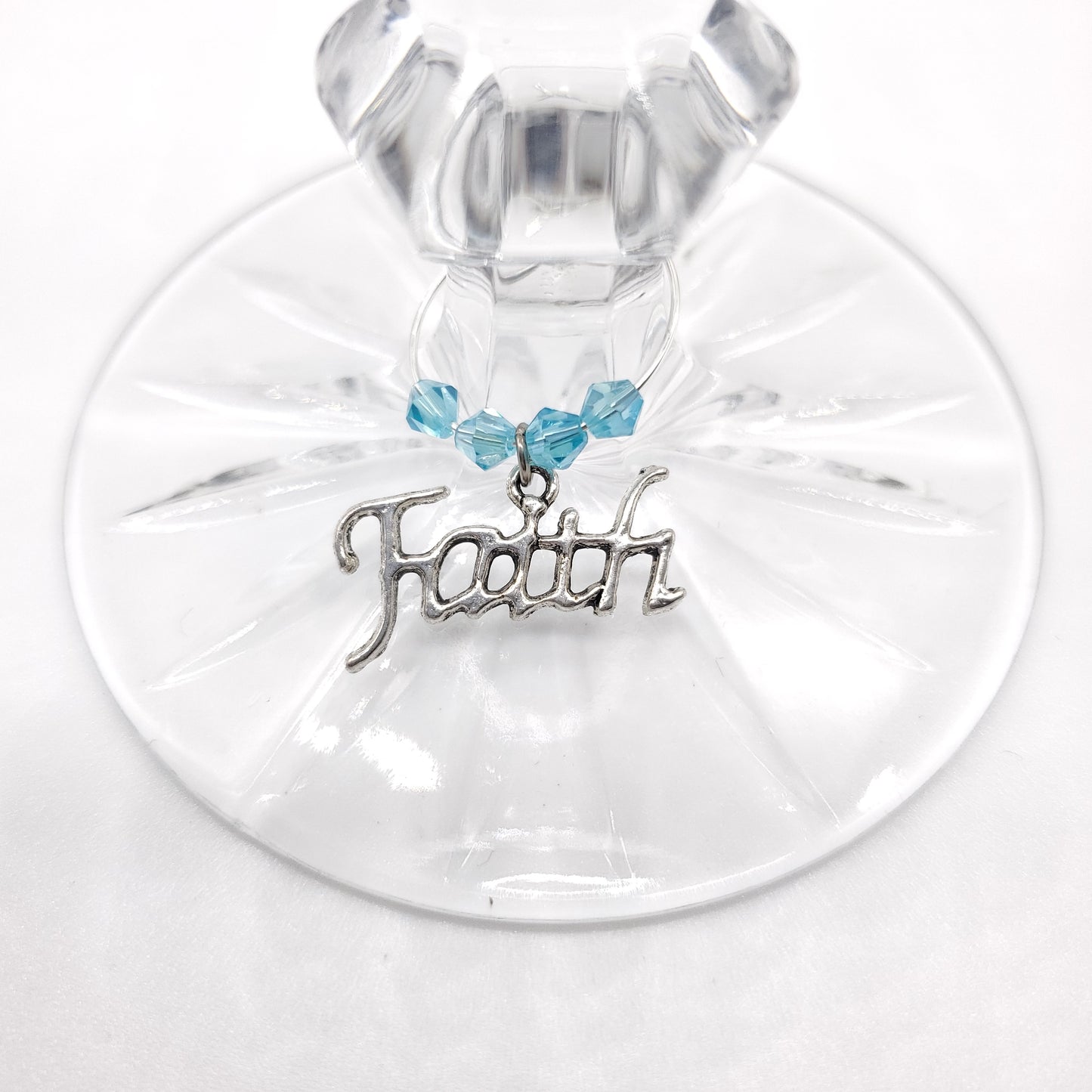 faith wine charm on a glass with aqua color crystal beads