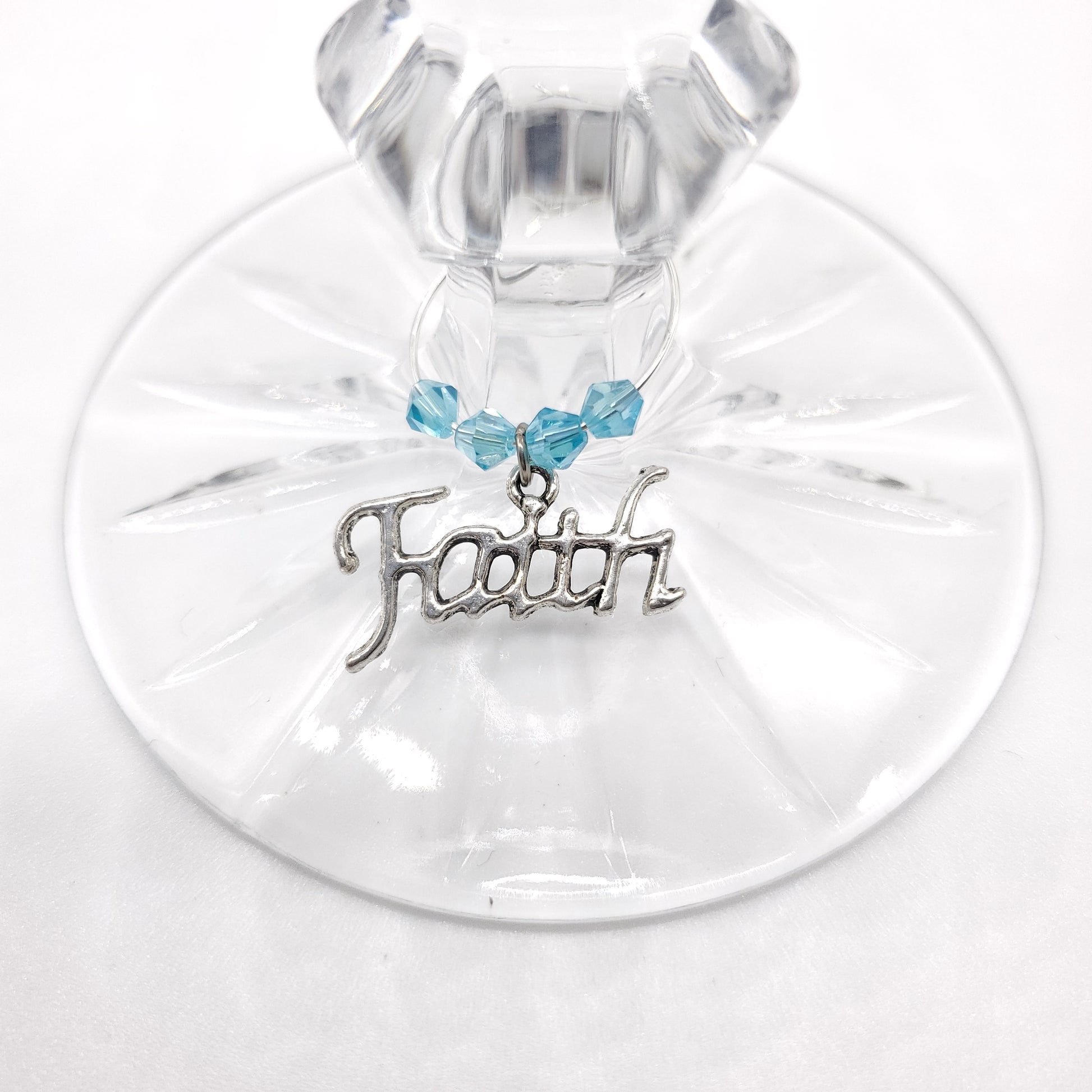 faith wine charm on a glass with aqua color crystal beads