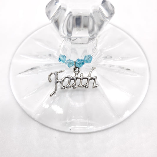 faith wine charm on a glass with aqua color crystal beads
