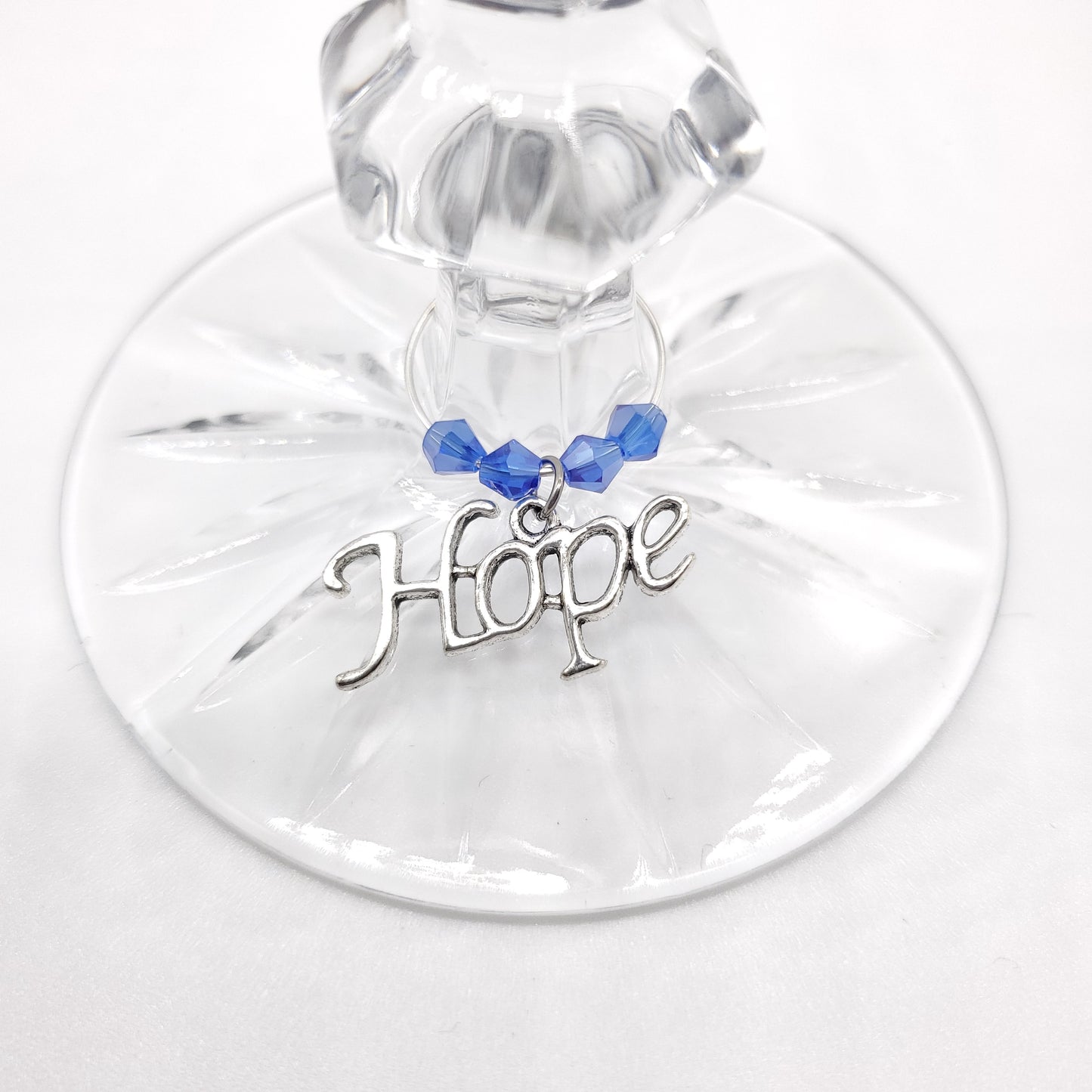 hope wine charm on a glass with blue crystal beads