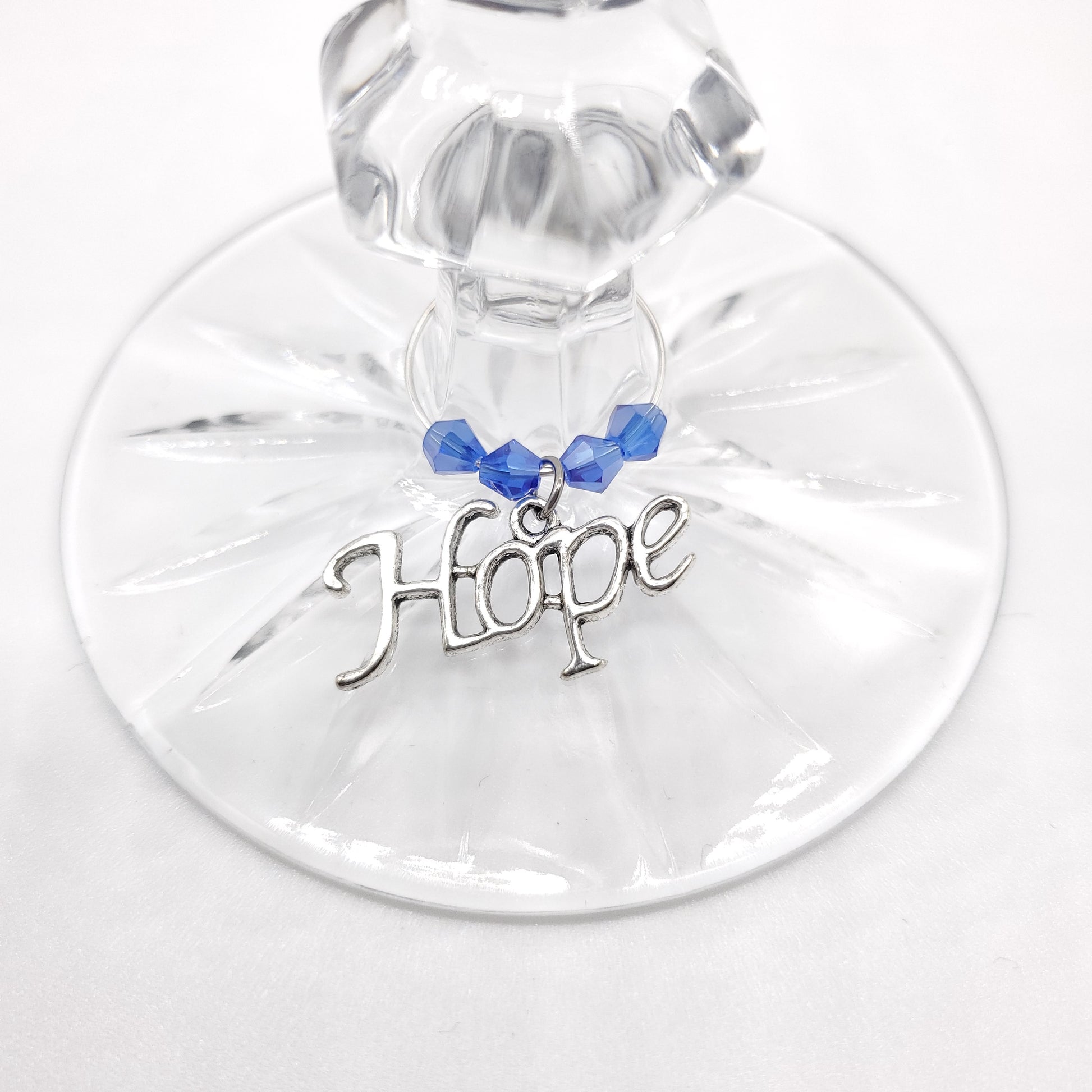 hope wine charm on a glass with blue crystal beads